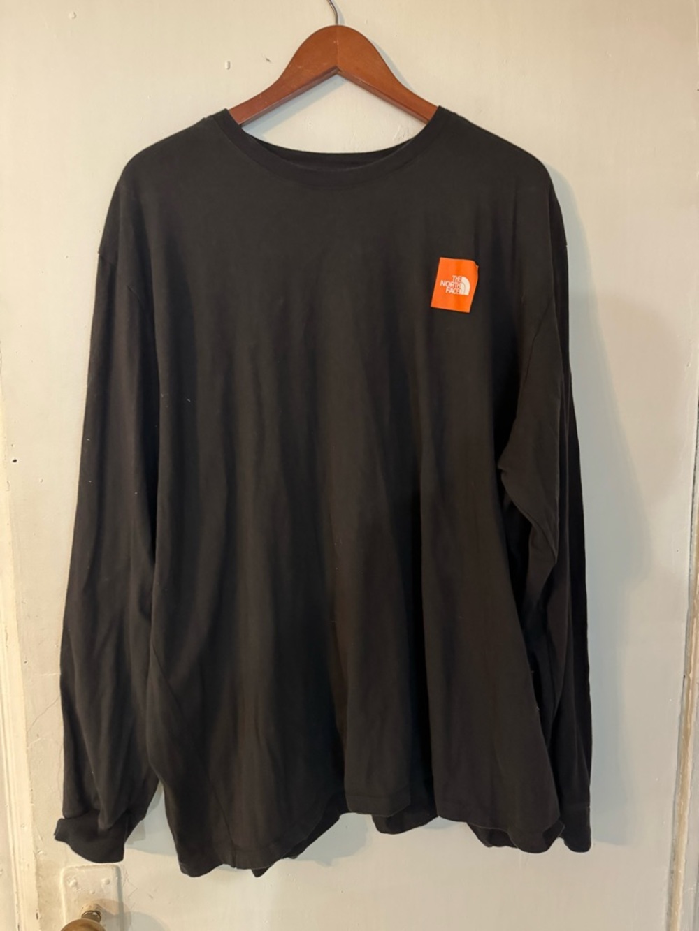 The North Face Long Sleeve Crew Tee in Black with Orange Logo